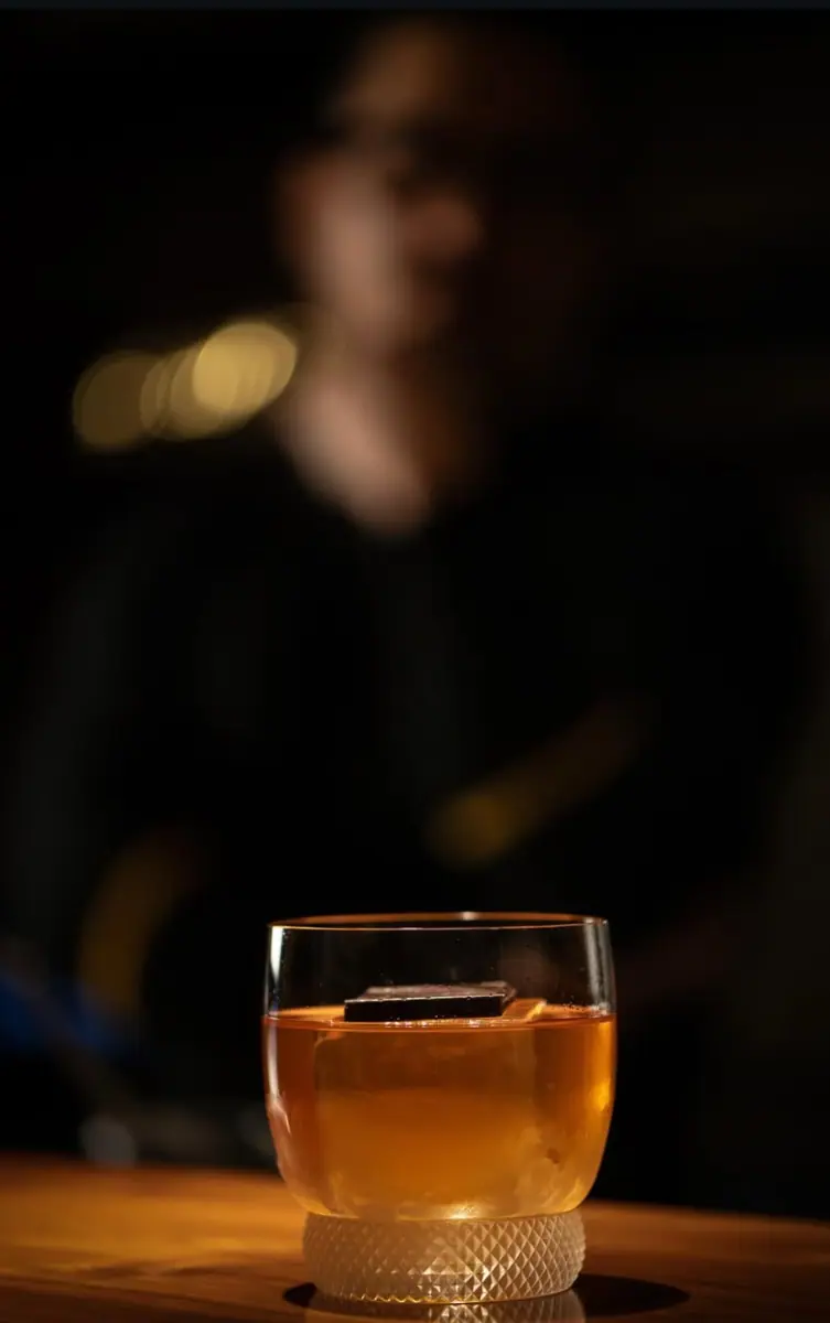 Blur shot of Bartender standing behind a drink